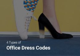 A pair of different shoes - white sneakers and black high heels - showing the diversity in office dress codes.