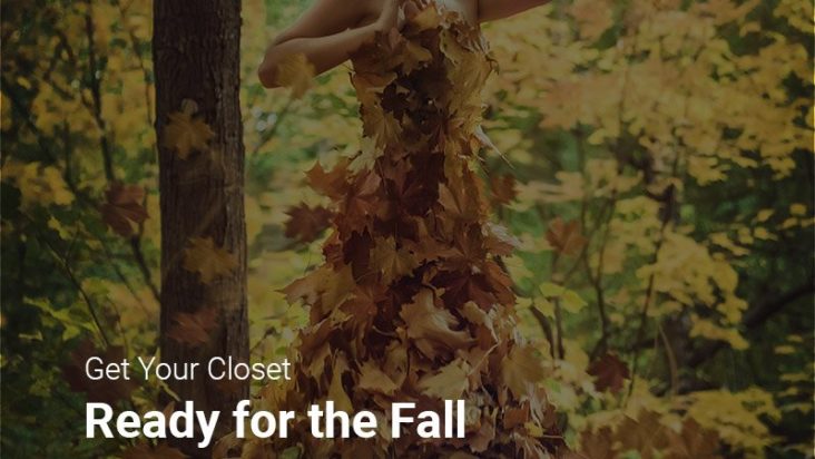 A woman depicting autumn fashion trends, wearing a dress covered in fall leaves.